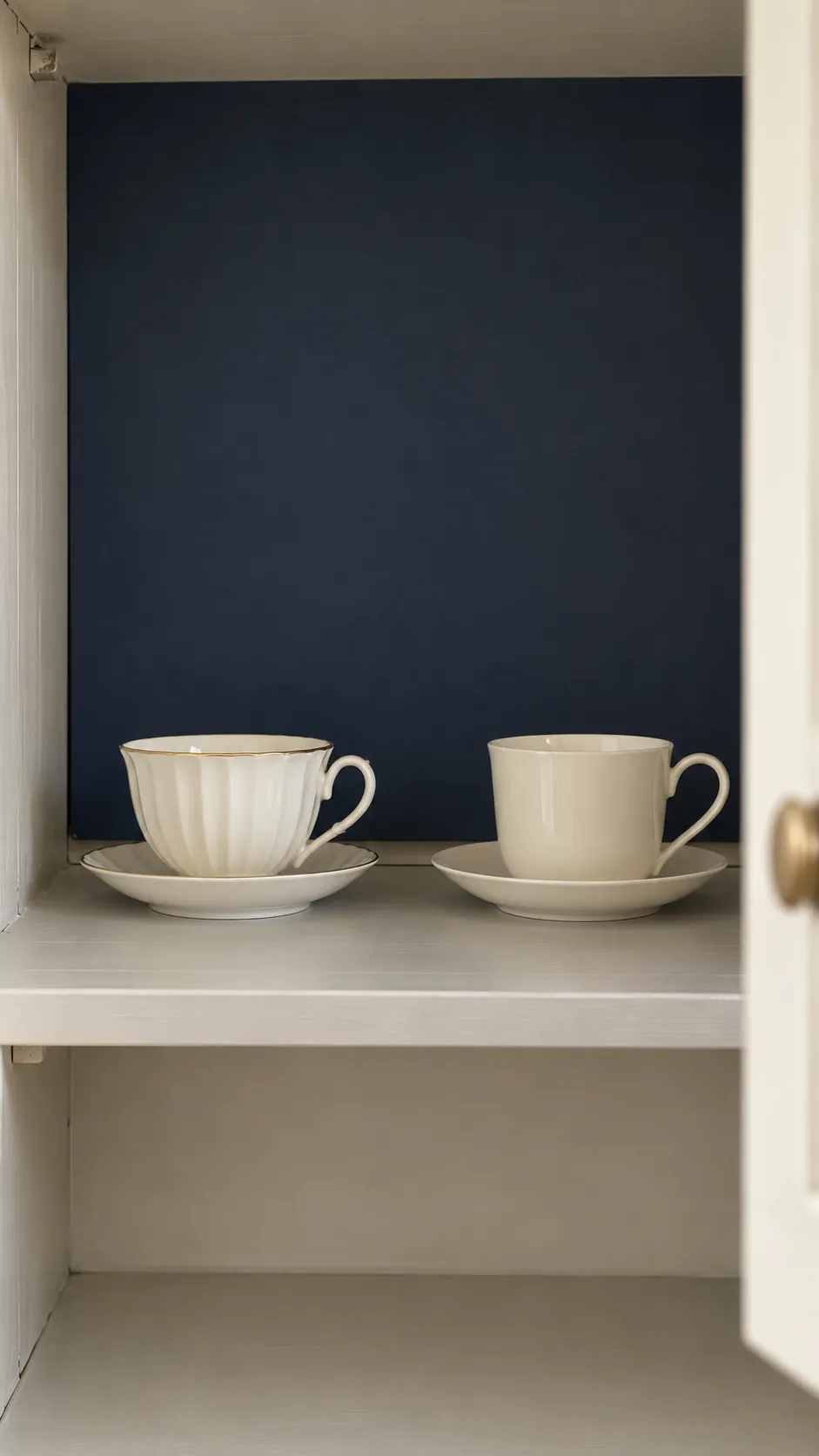 Let a dark cabinet backing define pale china with inherited teacups