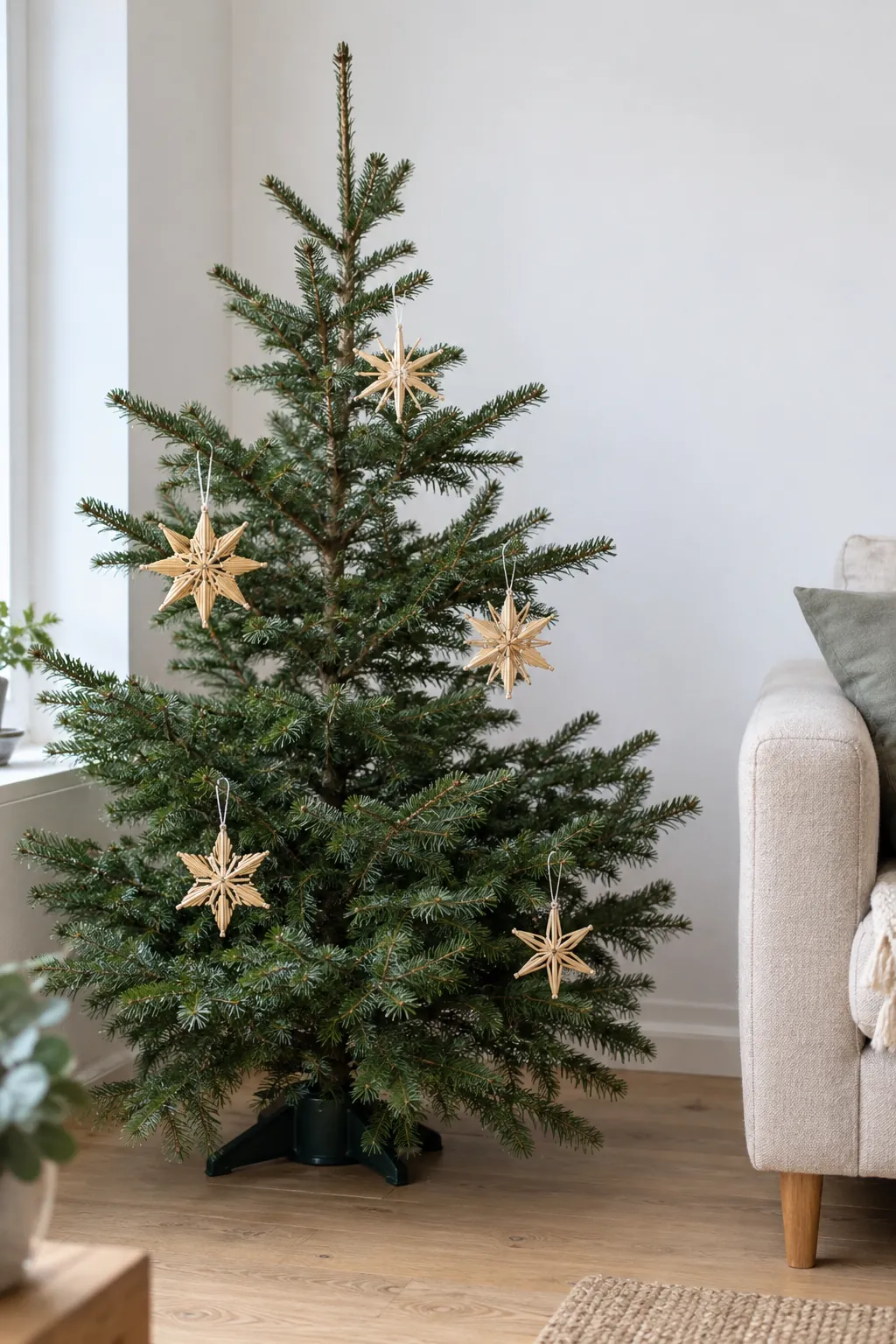Straw stars on a sparse tree in a natural Christmas home