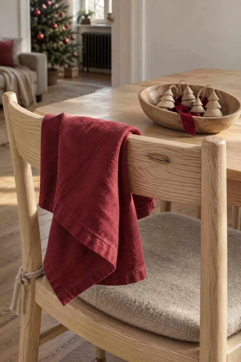 Cranberry linen linking Christmas accents to pale wood furniture