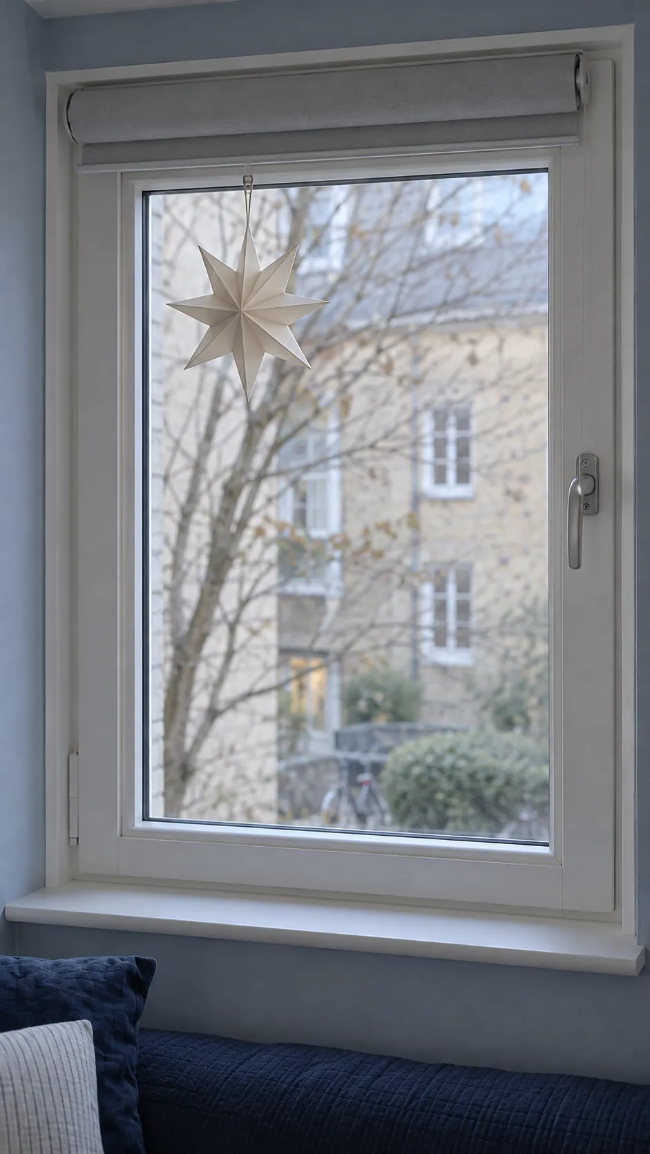 Use a window ornament sparingly in a practical Christmas guest bedroom