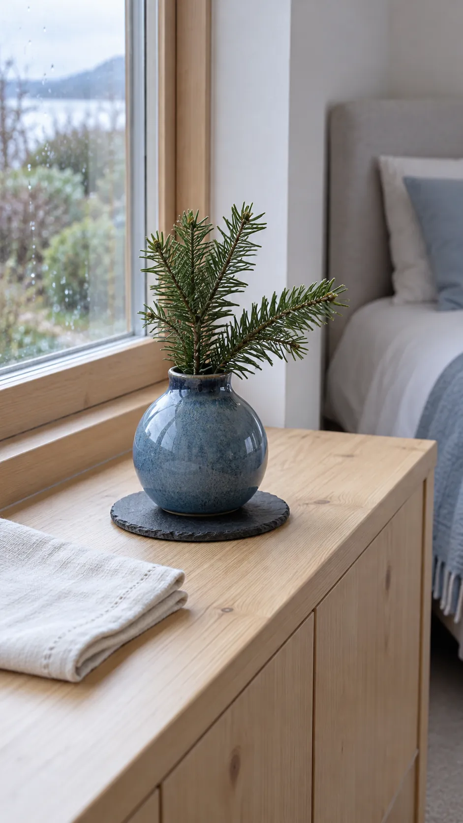 Choose an unscented botanical accent in a practical Christmas guest bedroom