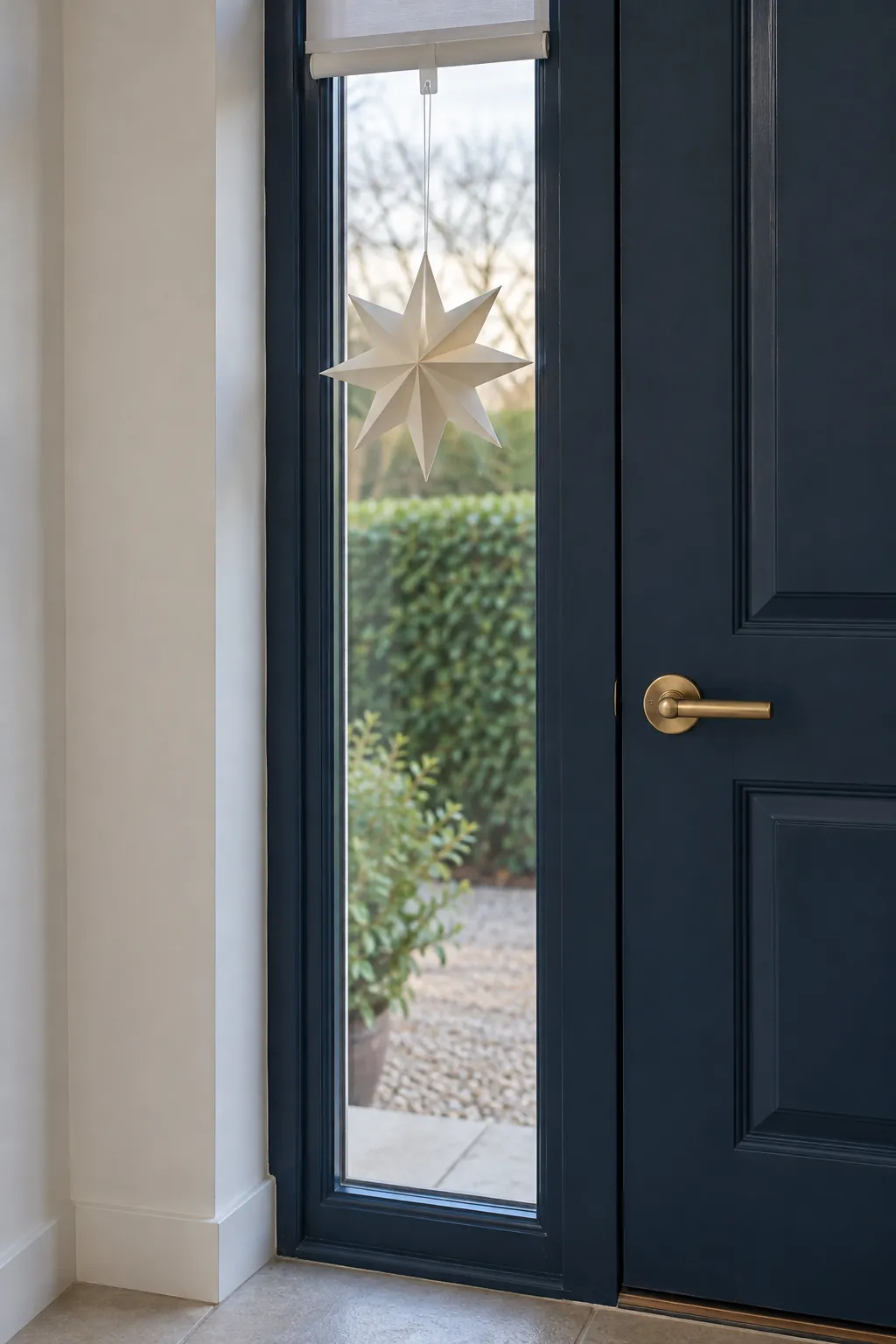 Hang a paper star in the side window in a Christmas entryway without a tree