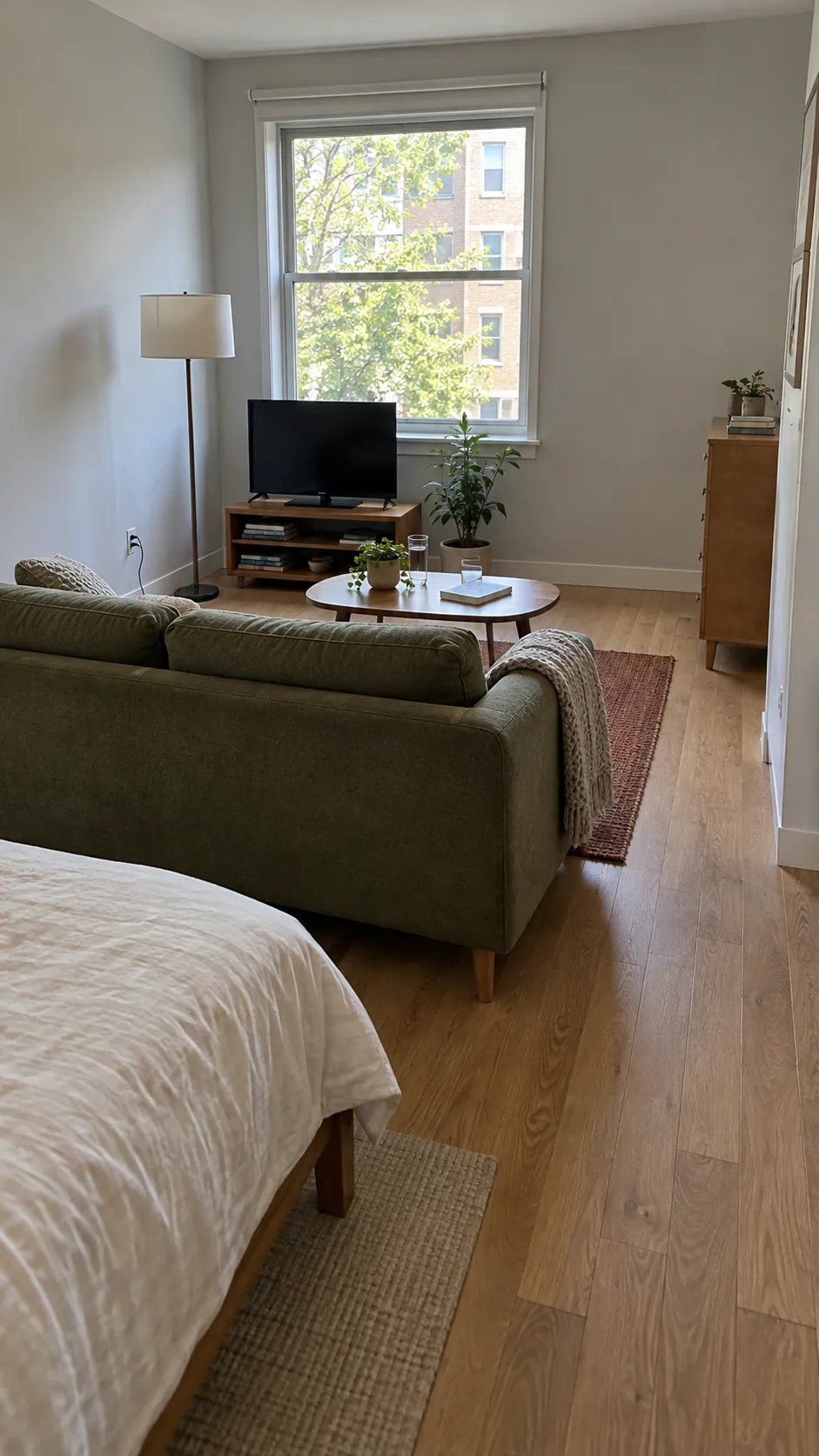 Low sofa back separating a sitting area from a bed