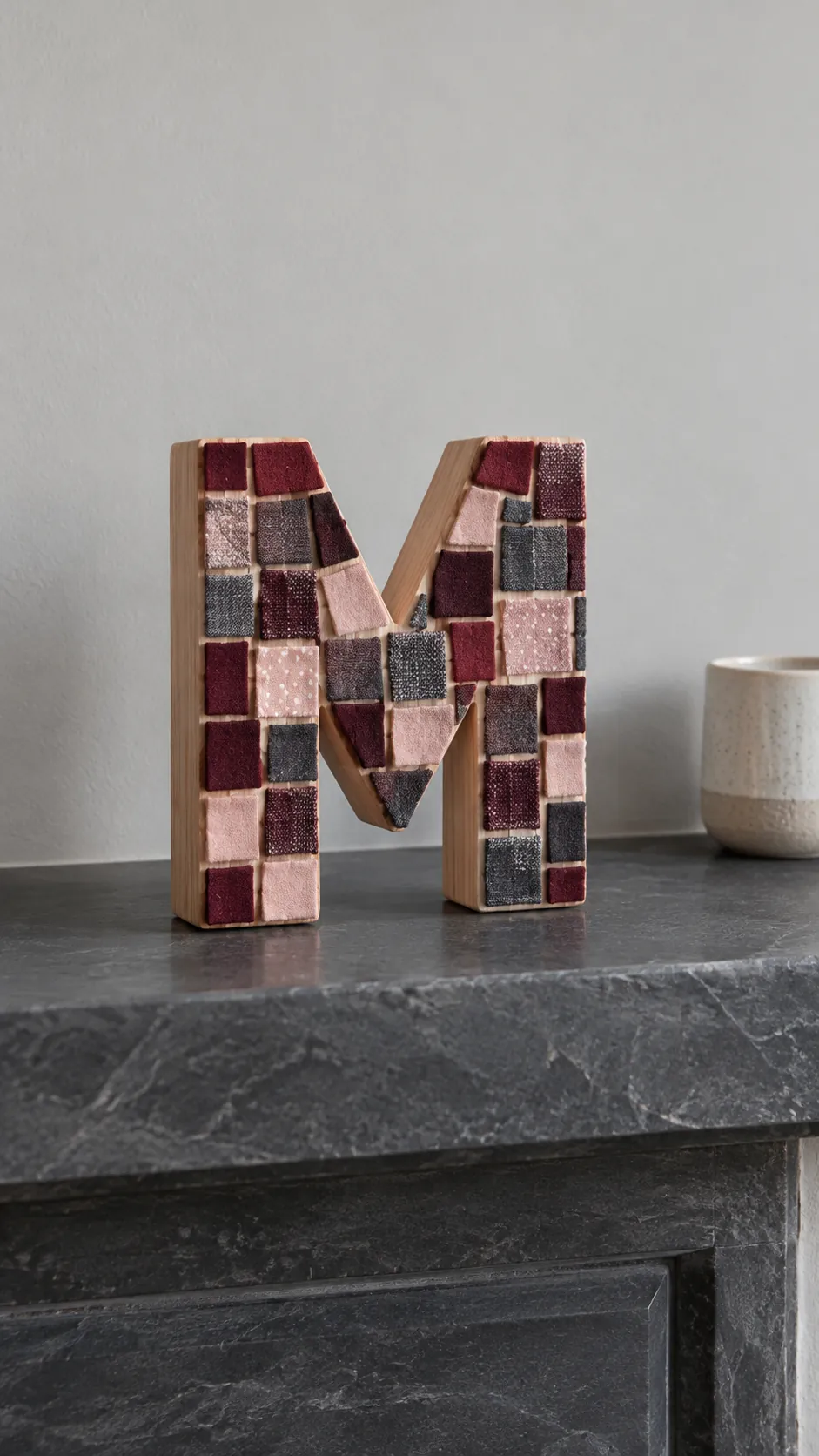 Small fabric tiles covering a decorative wooden initial