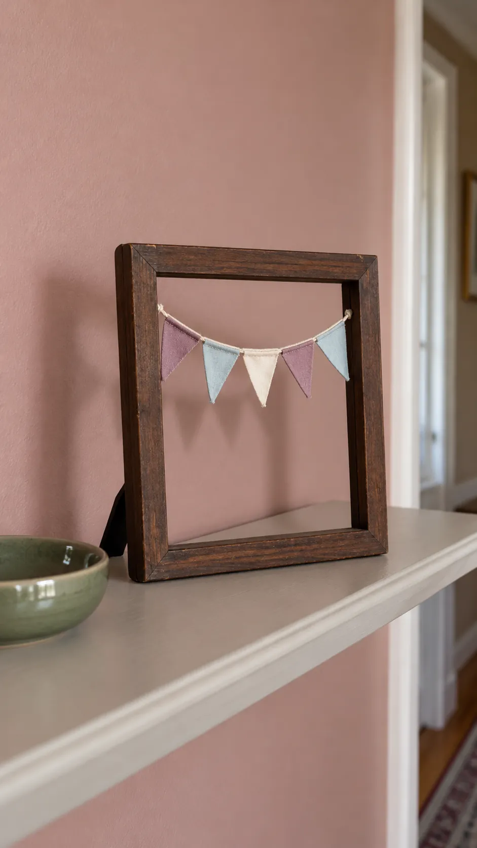 Tiny fabric bunting strung across an open tabletop frame
