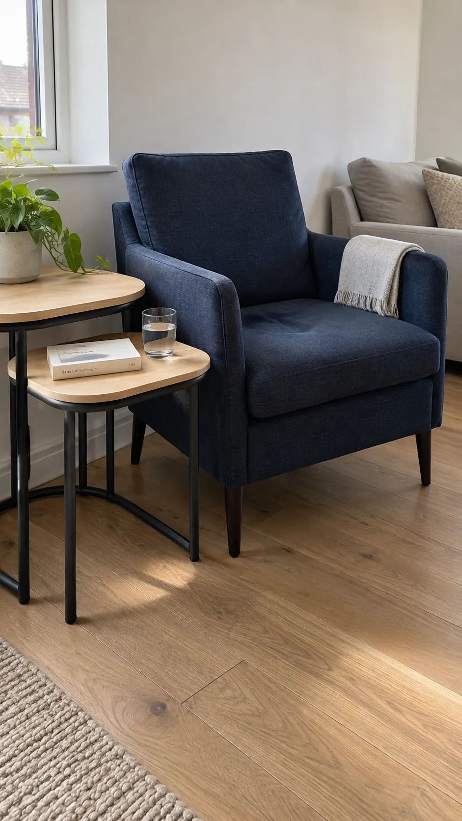 Slim armchair with nesting tables in a small living room