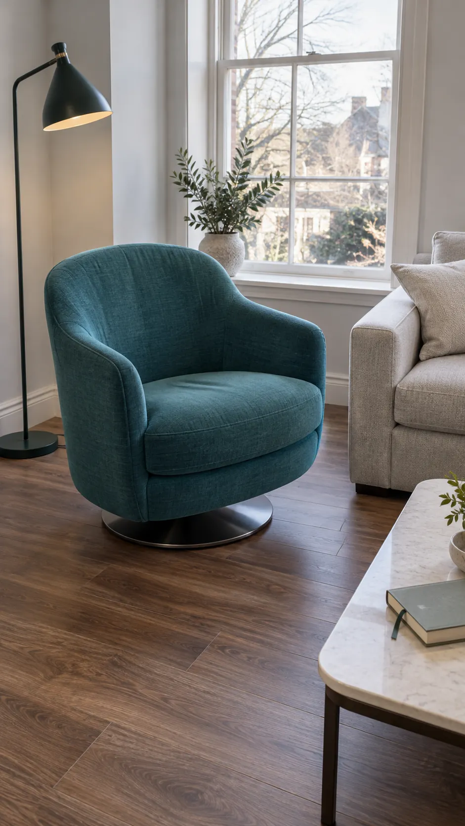 Compact swivel beside a sofa in a small living room