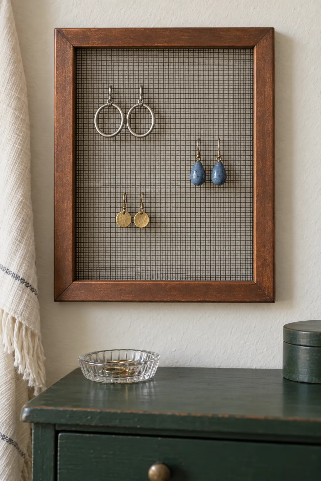 Fine mesh secured inside a frame with a few lightweight earrings