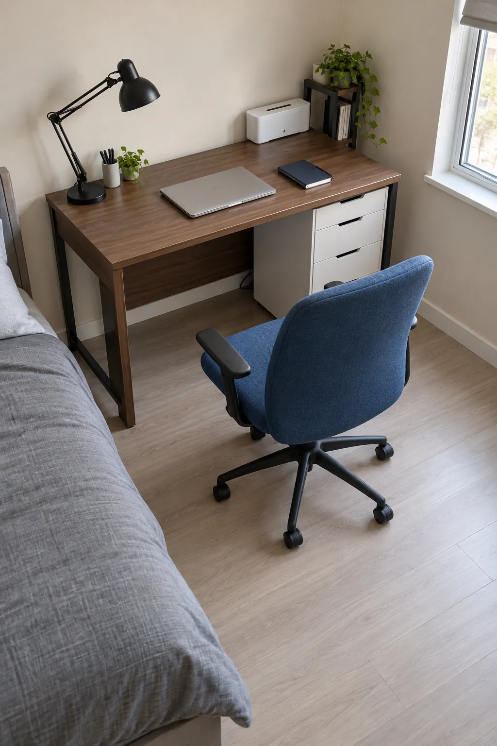 Compact bedroom desk with its chair pulled back and a clear cable route