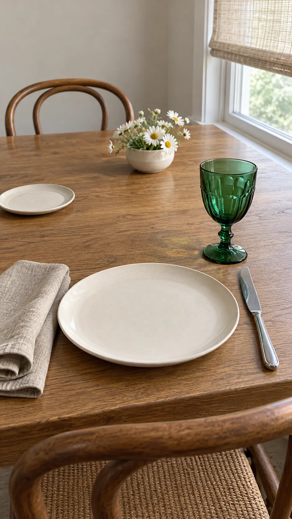 Emerald goblet with cream dishes and a quiet dining table