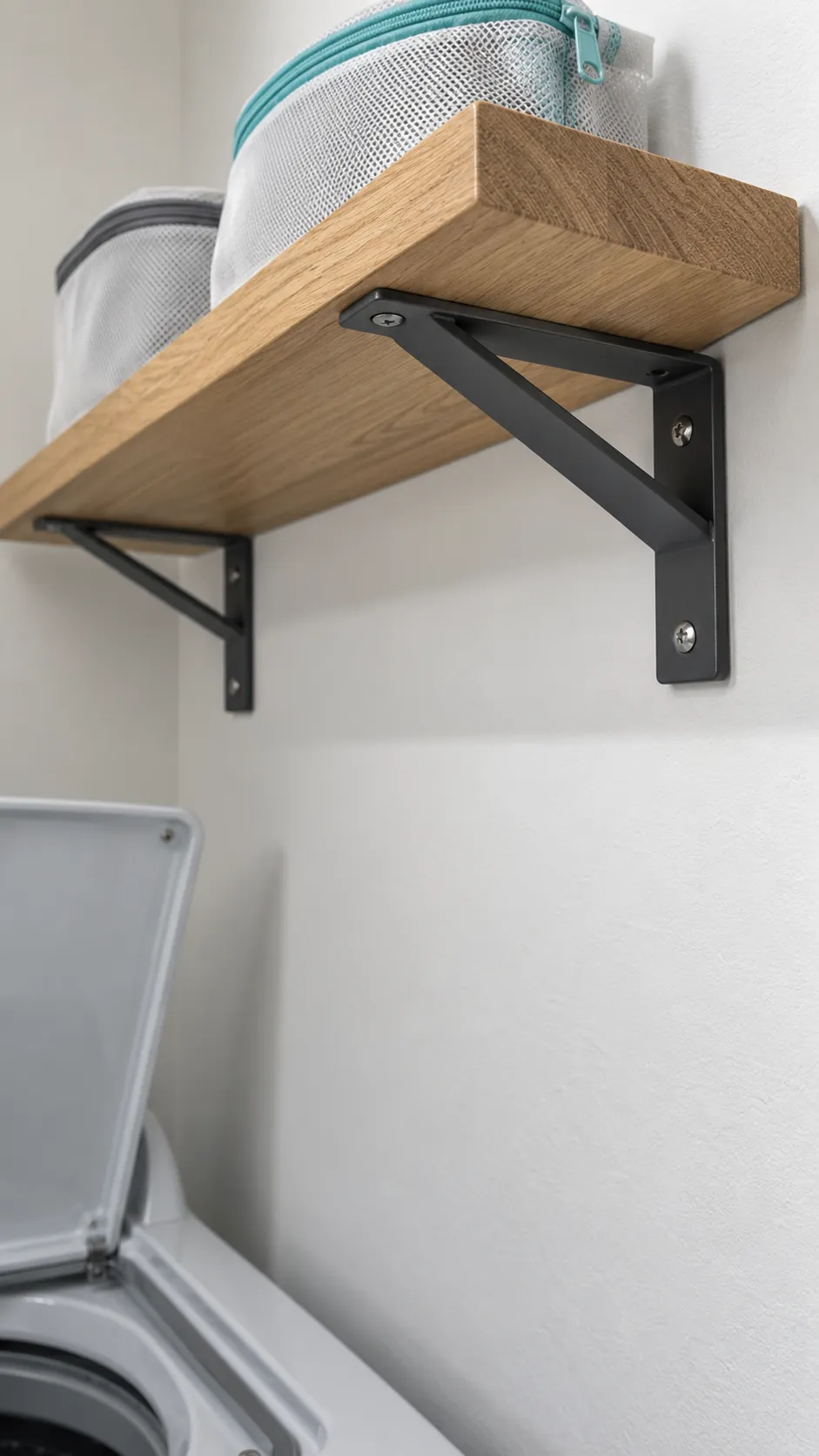 Include shelf depth, brackets, and anything hanging below for shelving above a top loading washer
