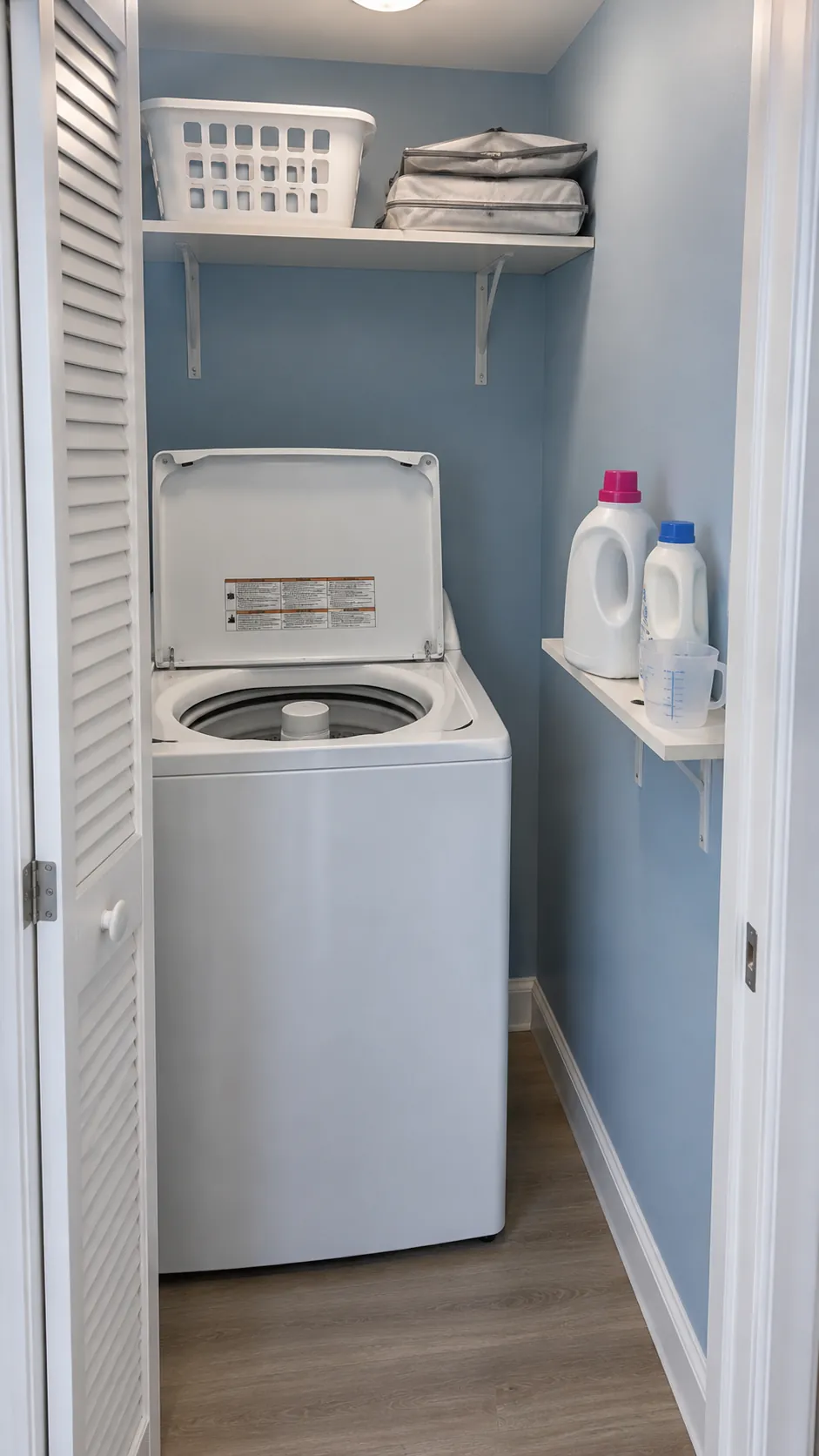 Separate overhead storage from daily reach for shelving above a top loading washer