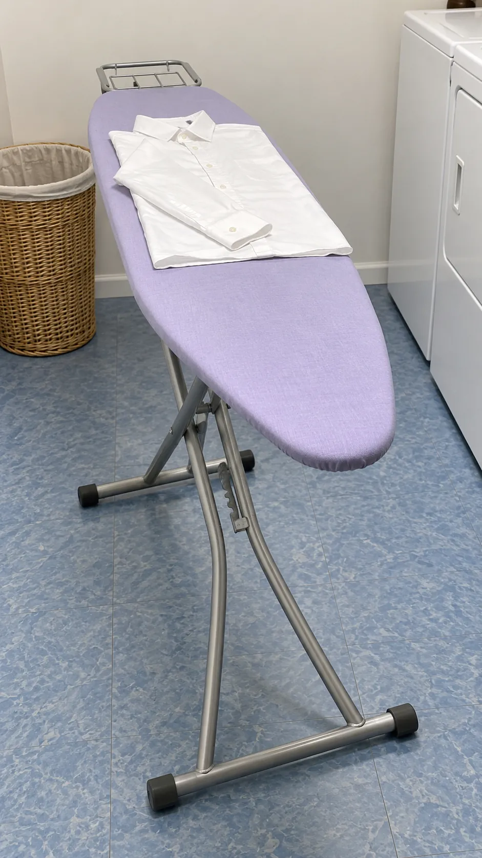 An ironing board used for shirts and small batches as a temporary small laundry folding station