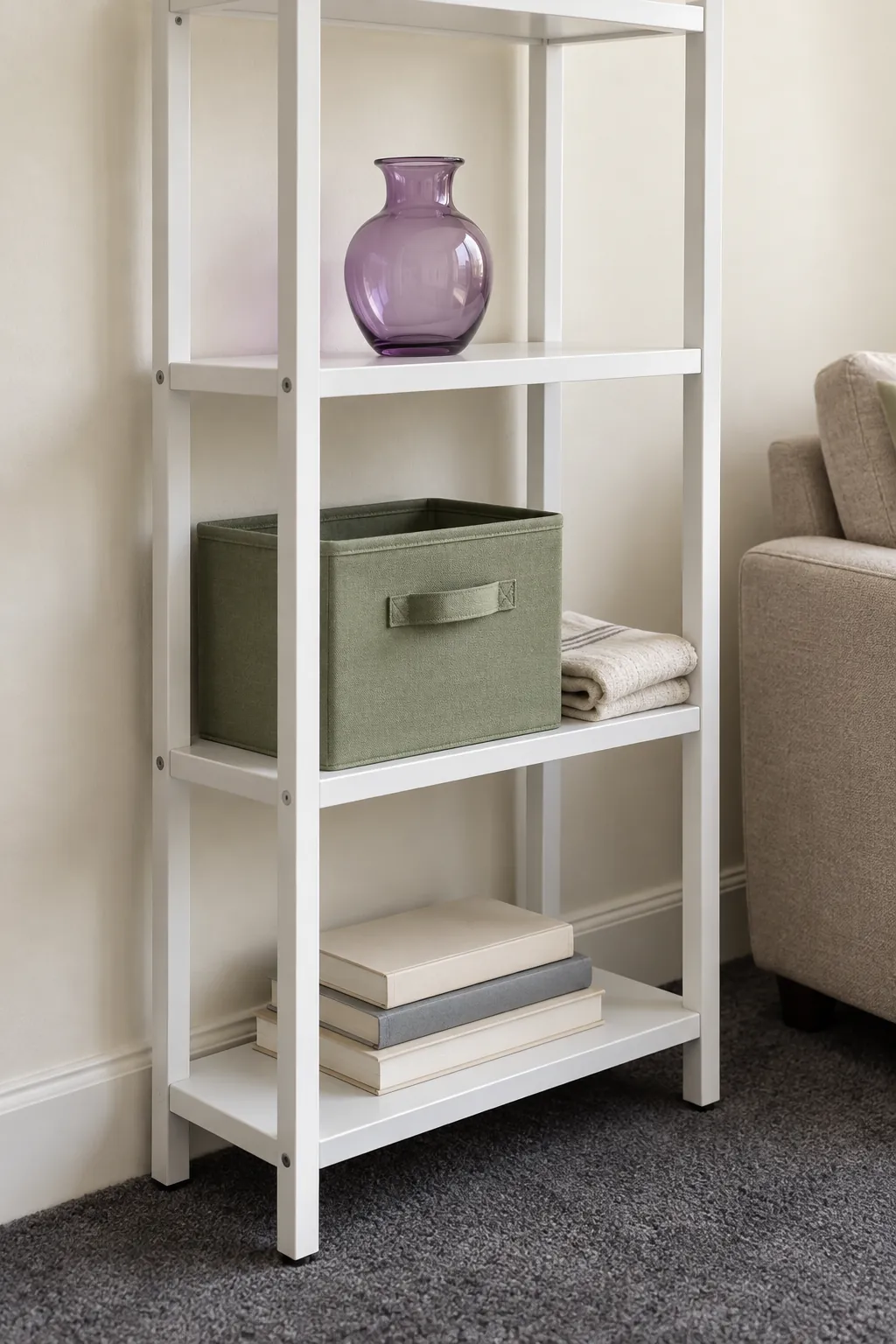 Green storage box and purple glass vase on a freestanding rental shelf