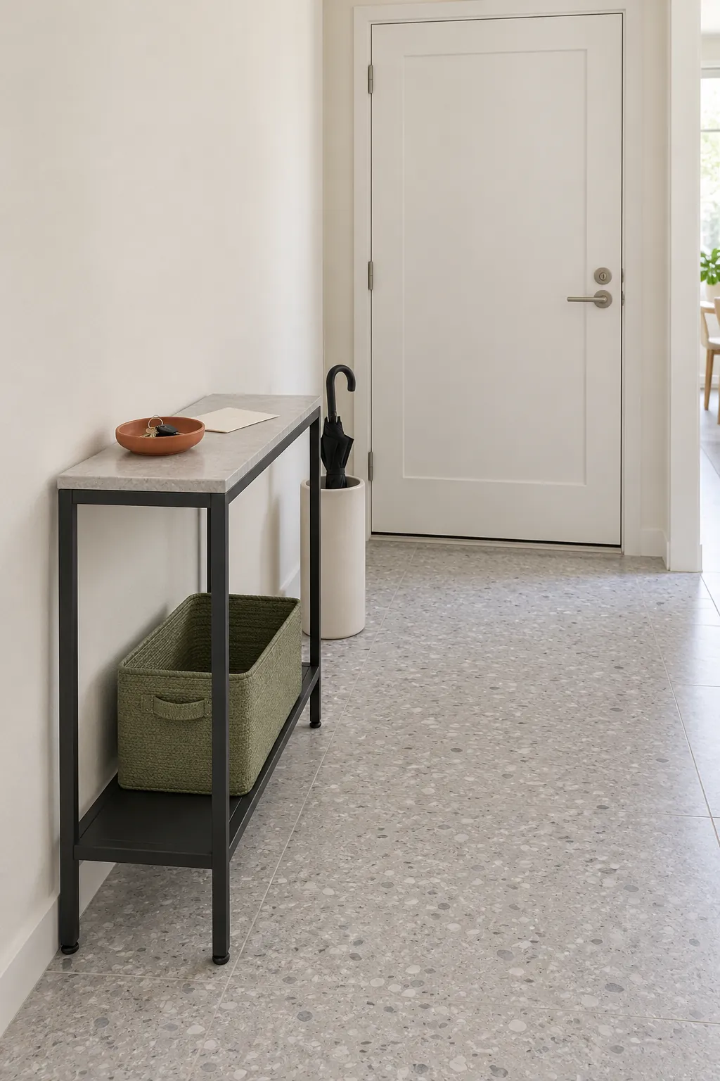 Charcoal entry console with green storage and an orange ceramic bowl