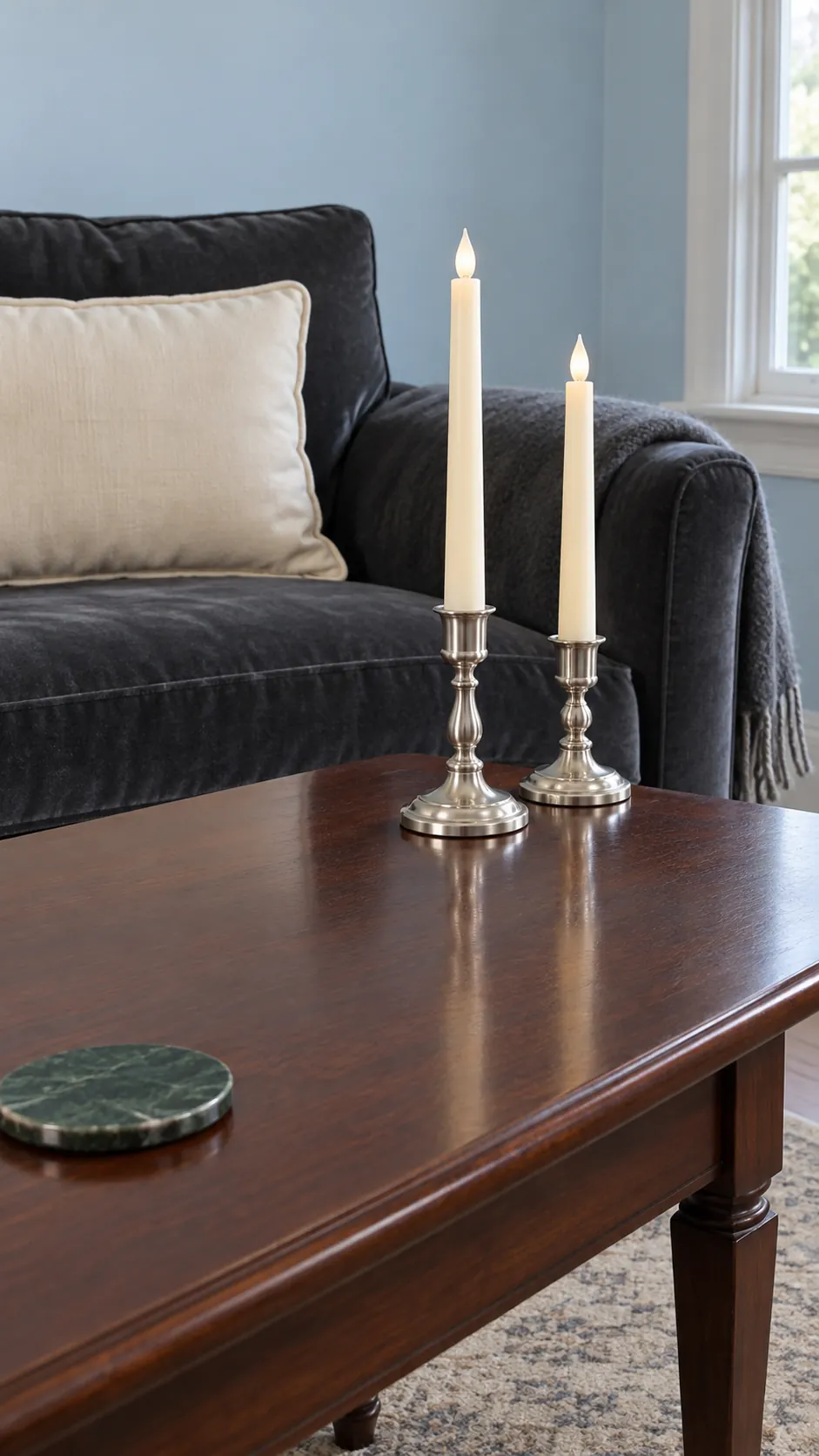 Use silver candle holders with flameless tapers on a Christmas coffee table