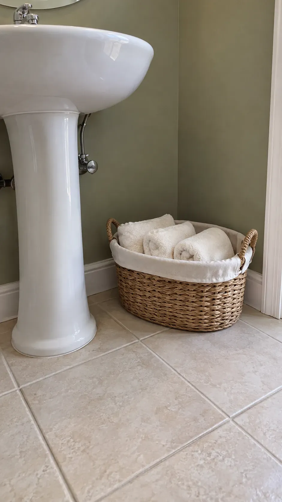 Dry basket storage, low corner view, olive wall and cream terry