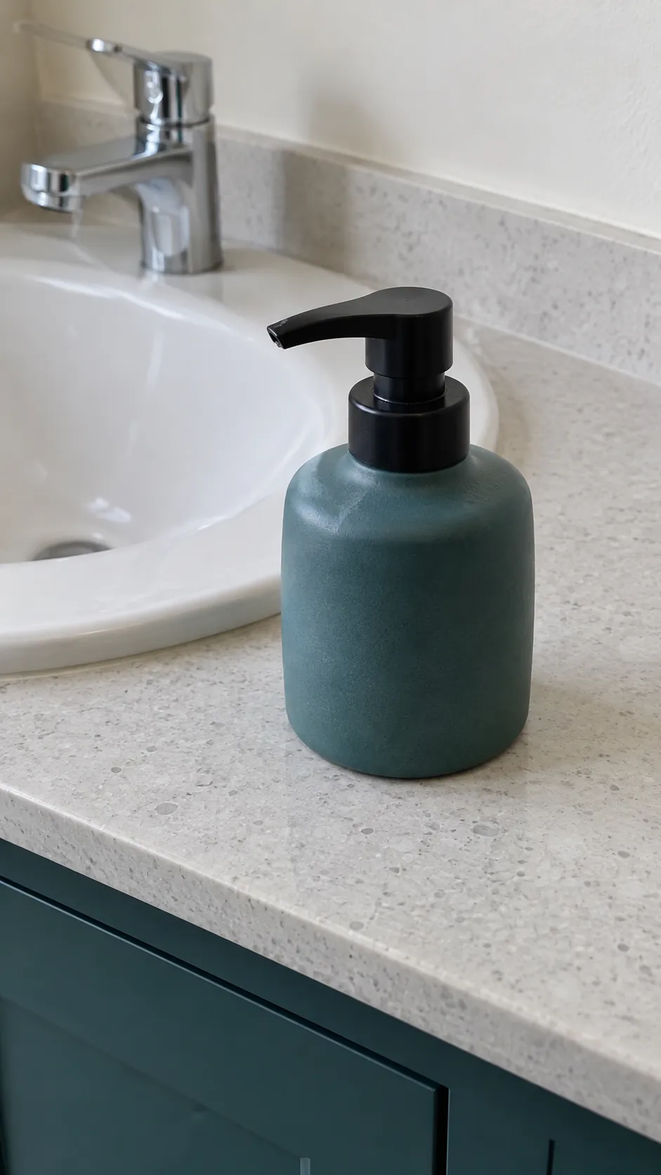 Matte ceramic soap vessel echoes the cabinet in an existing powder room