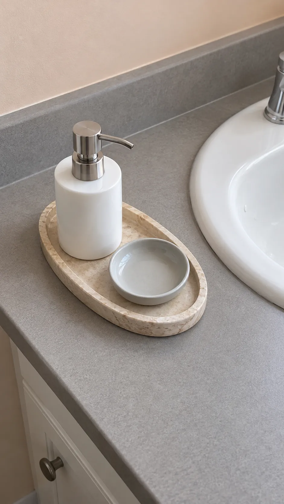A compact stone tray groups two essentials in an existing powder room