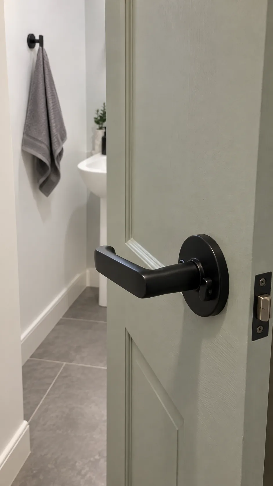 Dark privacy handle connects to dark fittings in an existing powder room