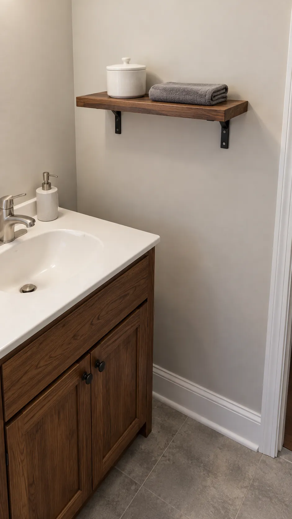 Walnut shelf echoes a retained wood cabinet in an existing powder room