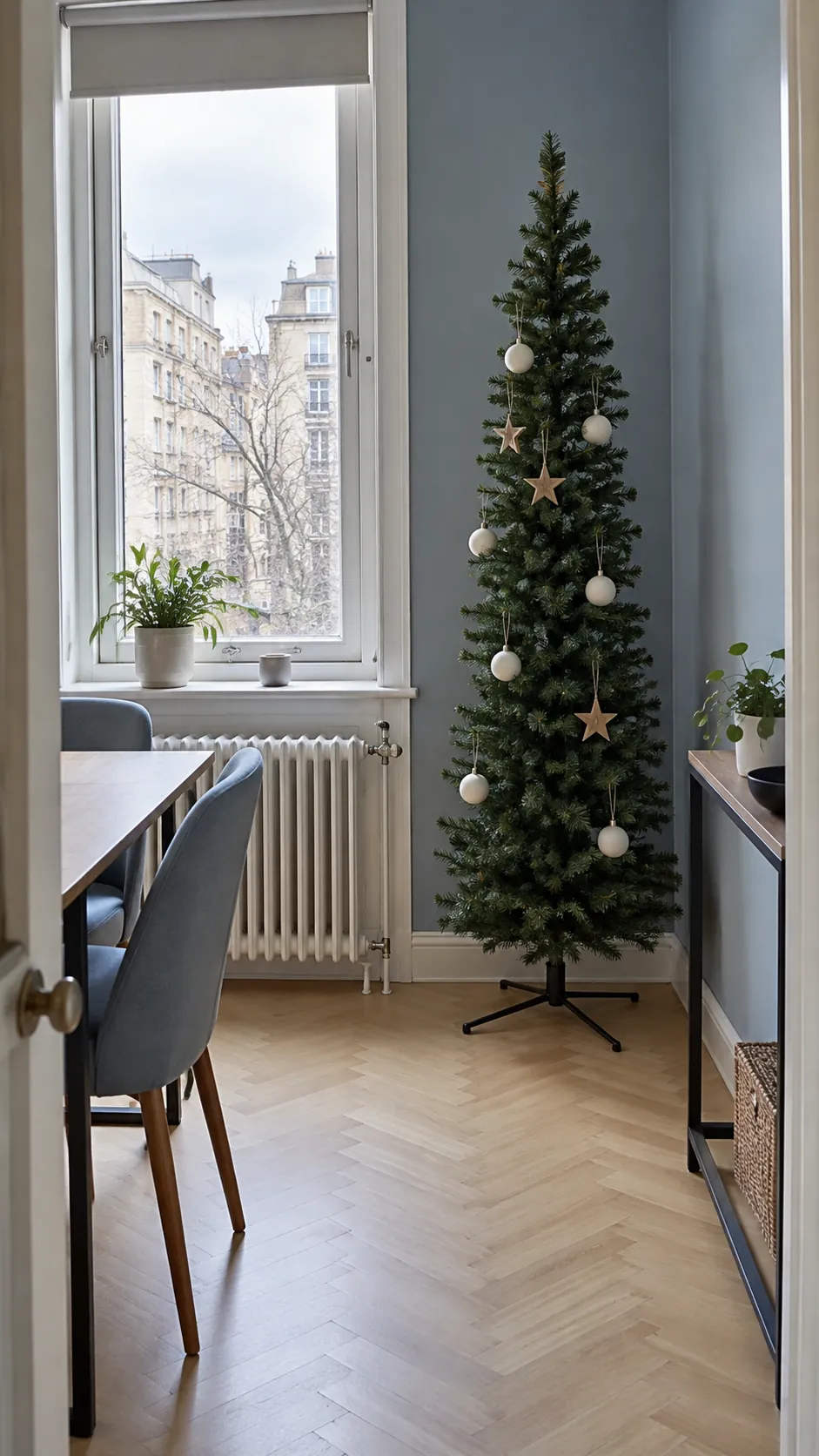 A slim tree beside an apartment window for minimalist Christmas decor
