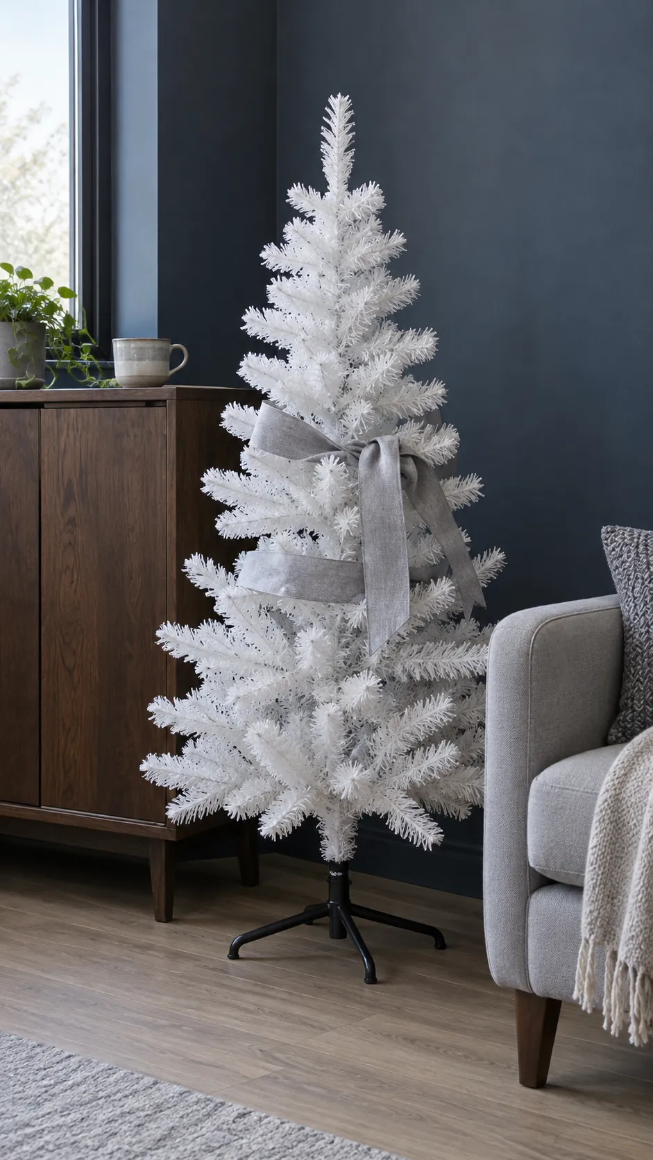 A small white tree against a darker background for minimalist Christmas decor