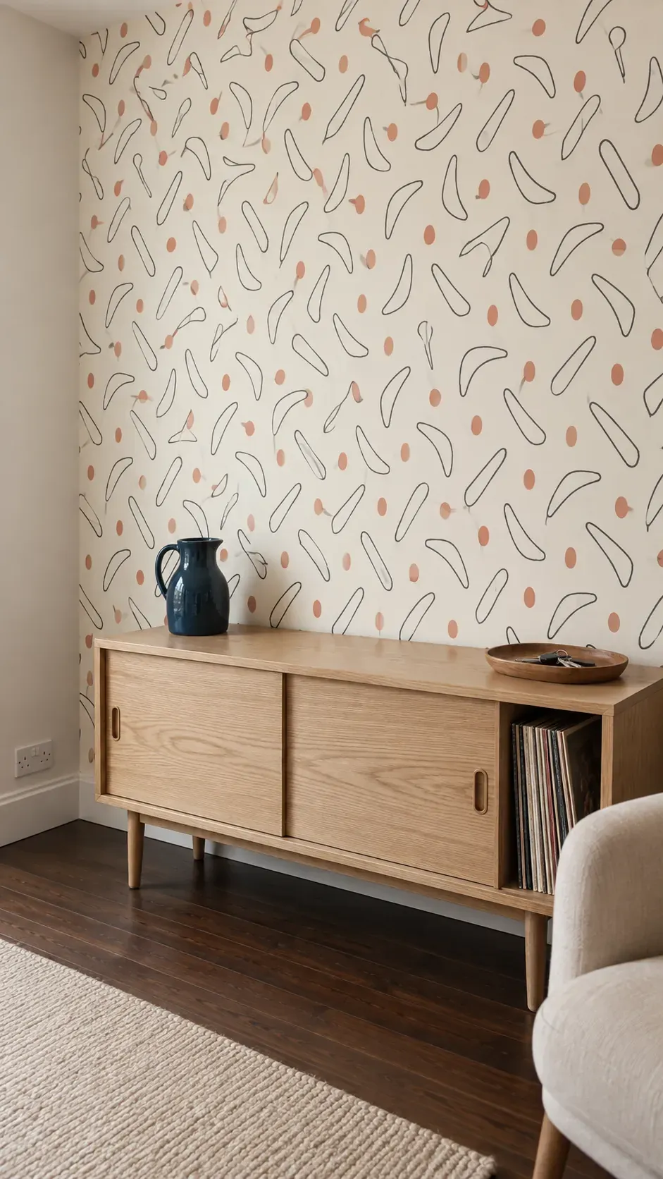 Boomerang pattern behind a modest sideboard inspired by 1950s interior design