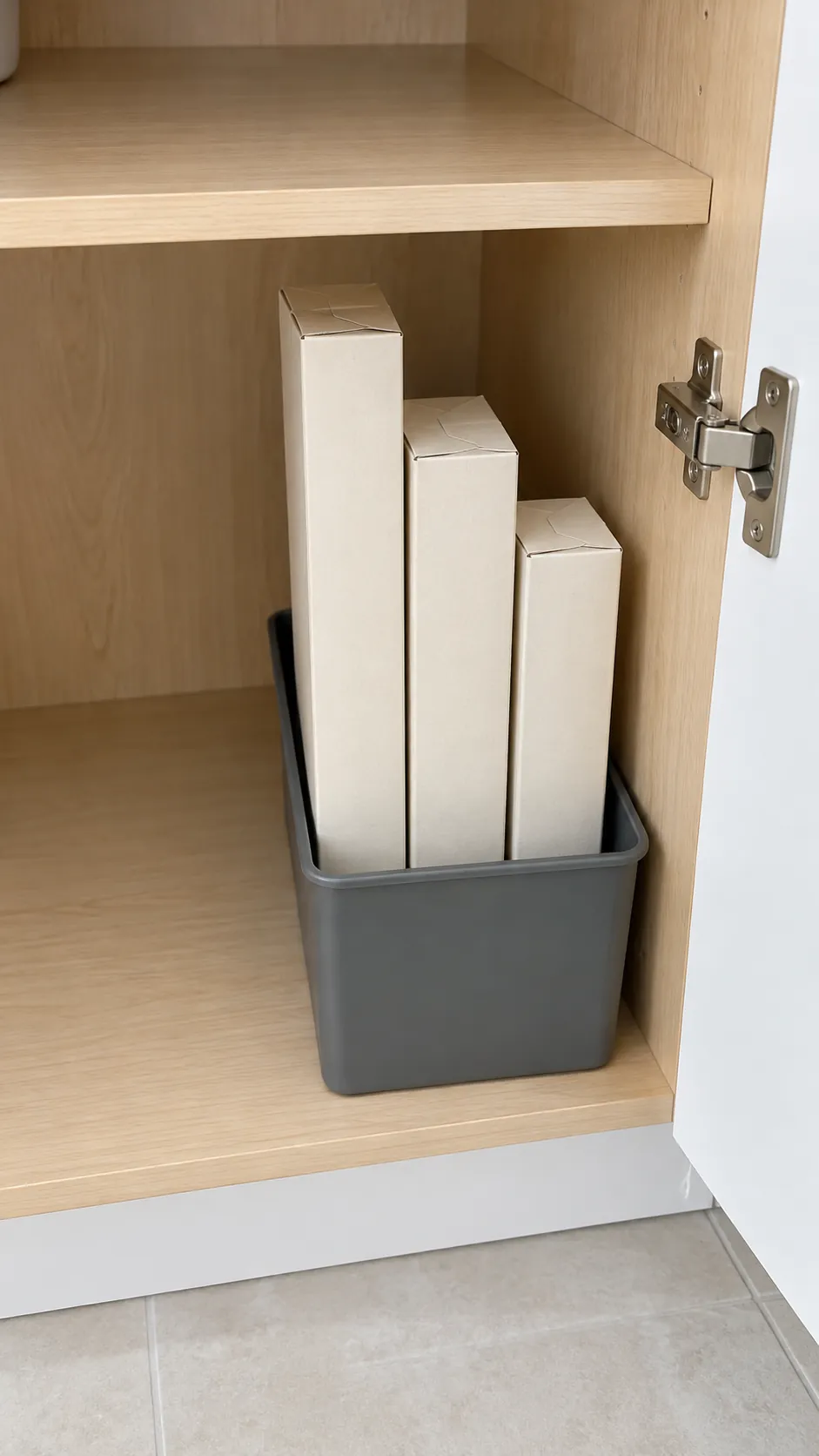 Upright wrap cartons contained in a sturdy narrow bin in a small rental kitchen