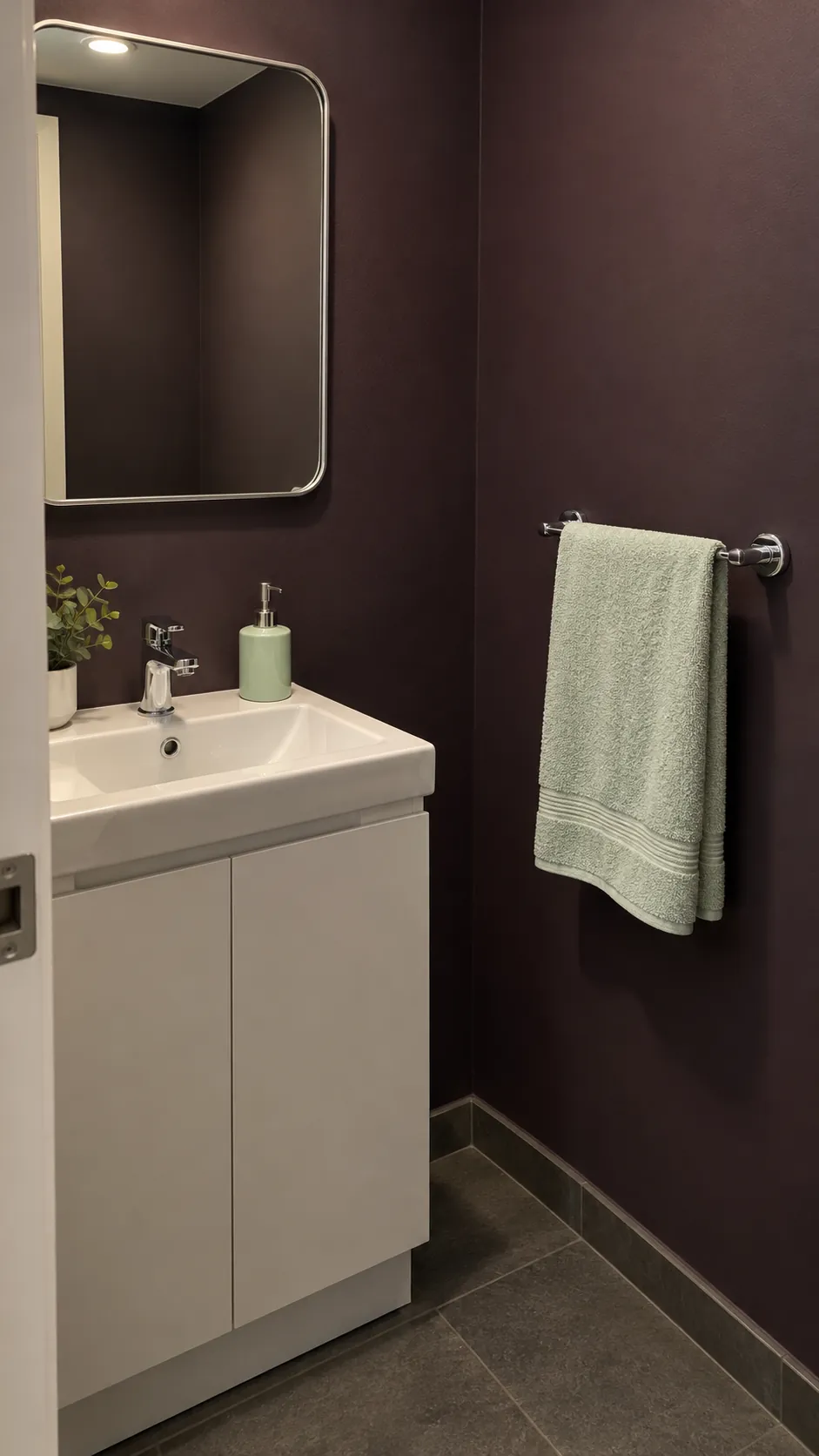 A light towel visible against a dark wall in a guest bathroom