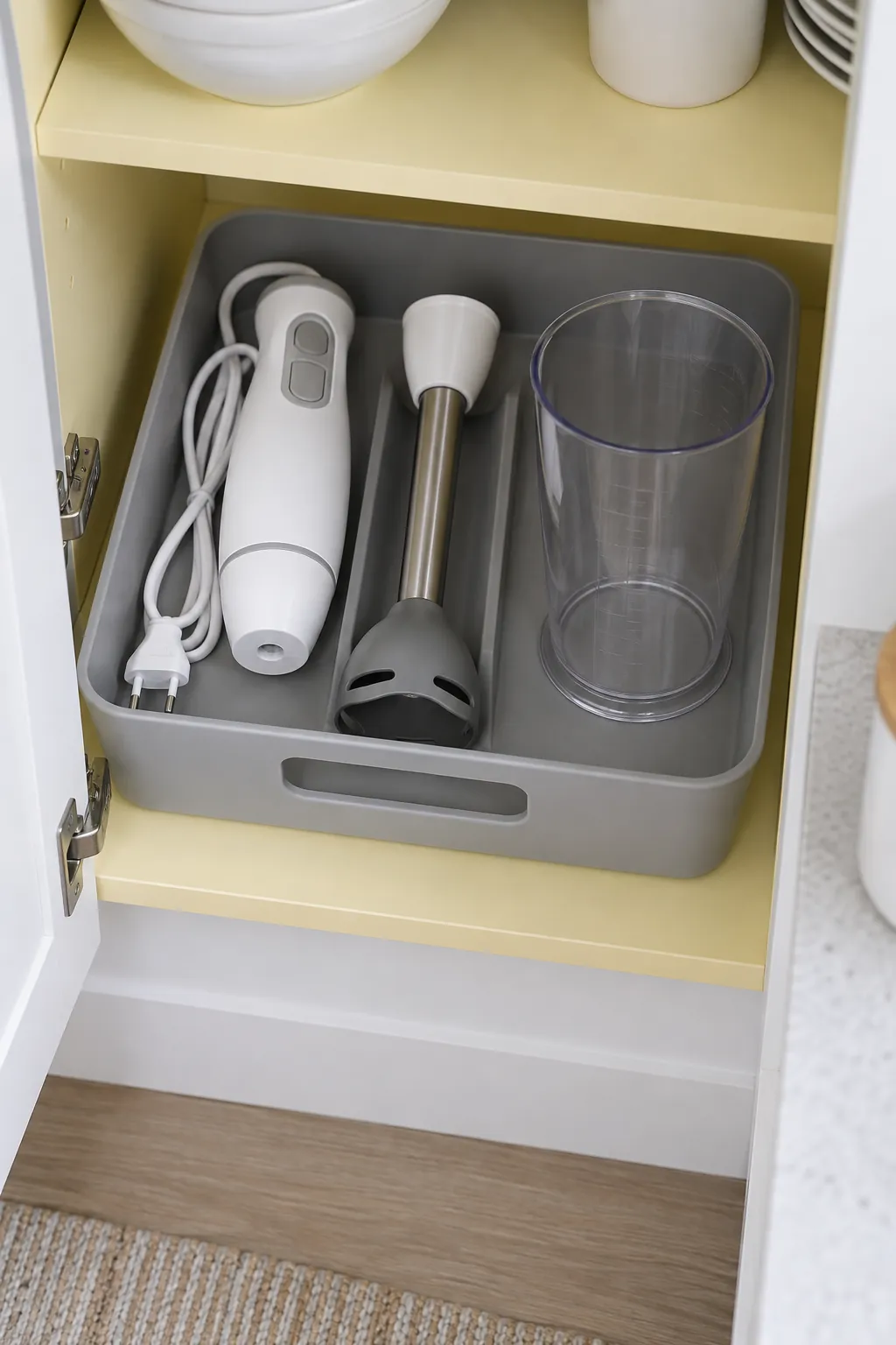 Immersion blender set organized in a shallow removable bin