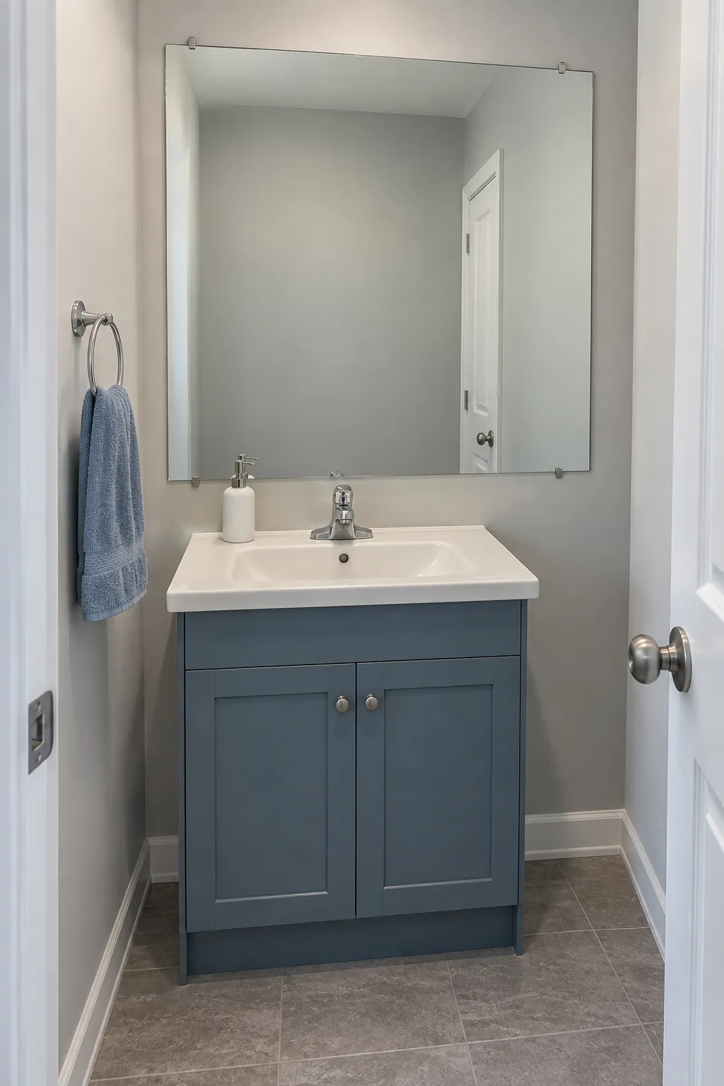 A large frameless mirror supported by a quiet lower palette in a powder room