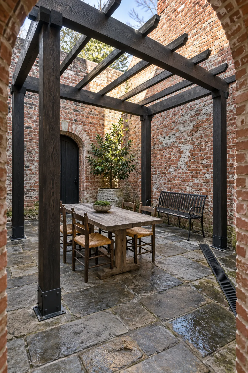 Dark timber pergola in a traditional brick courtyard