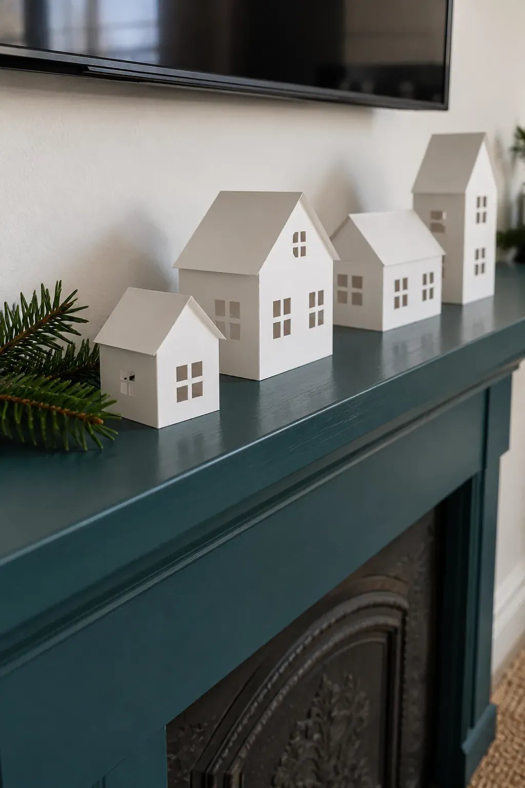 Build a low paper village on a Christmas mantel with a television