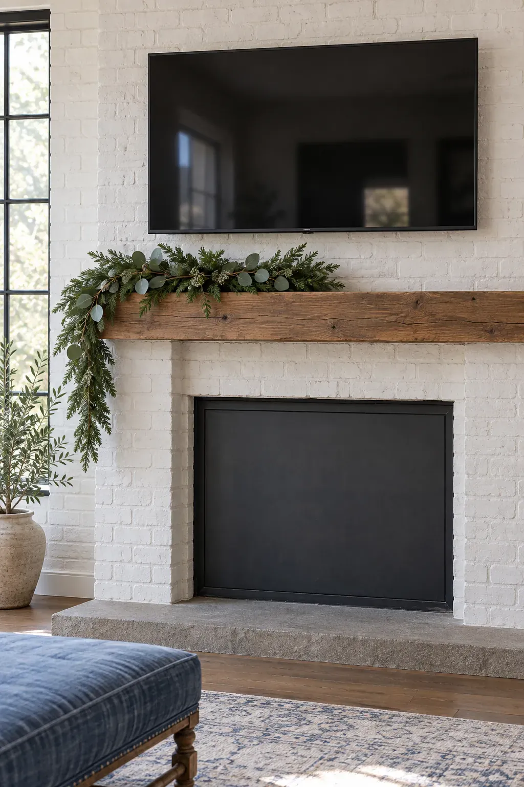 Make a short asymmetric greenery drop on a Christmas mantel with a television