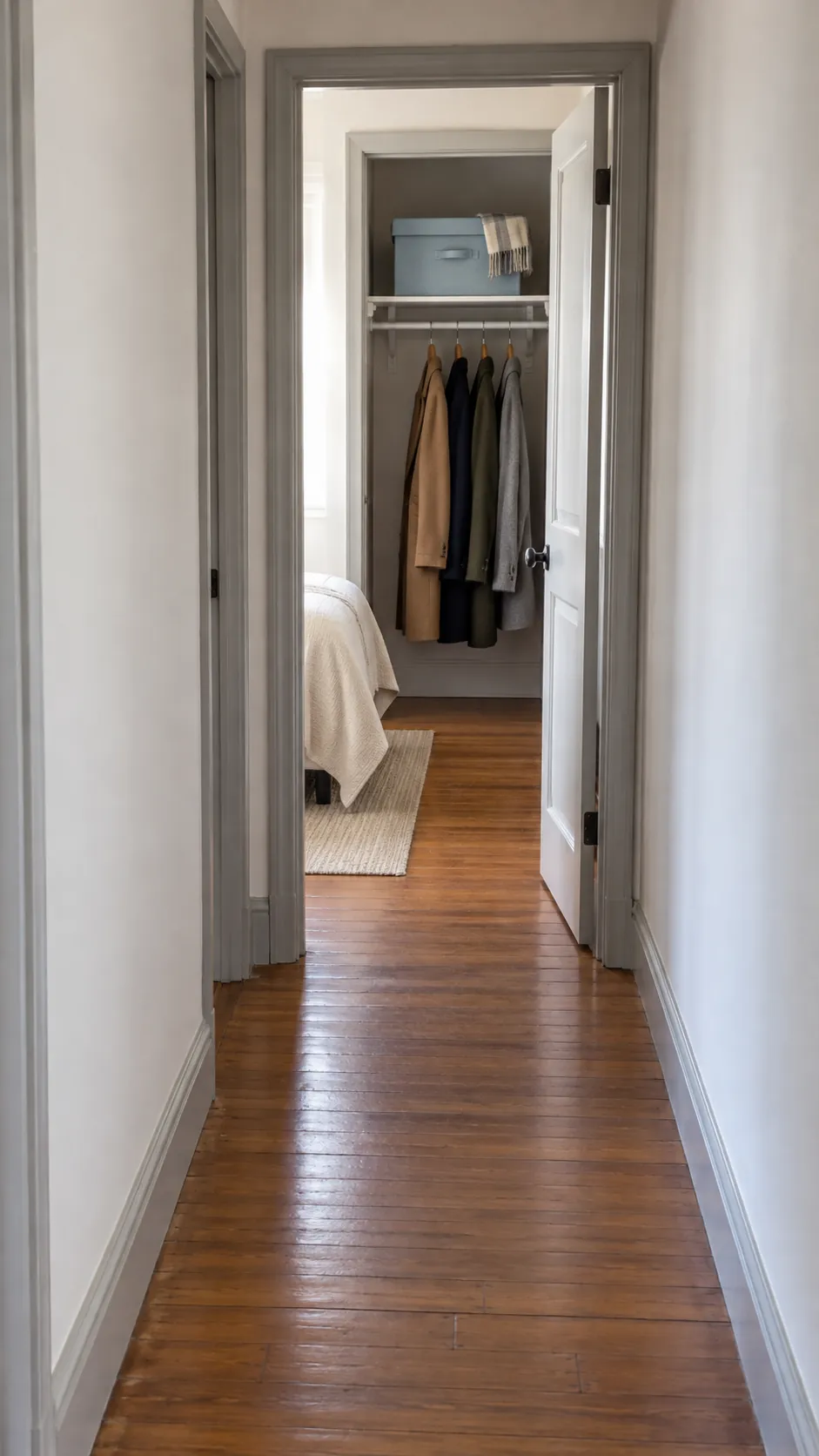 Seasonal accessories stored in an adjacent room closet beyond a clear hallway