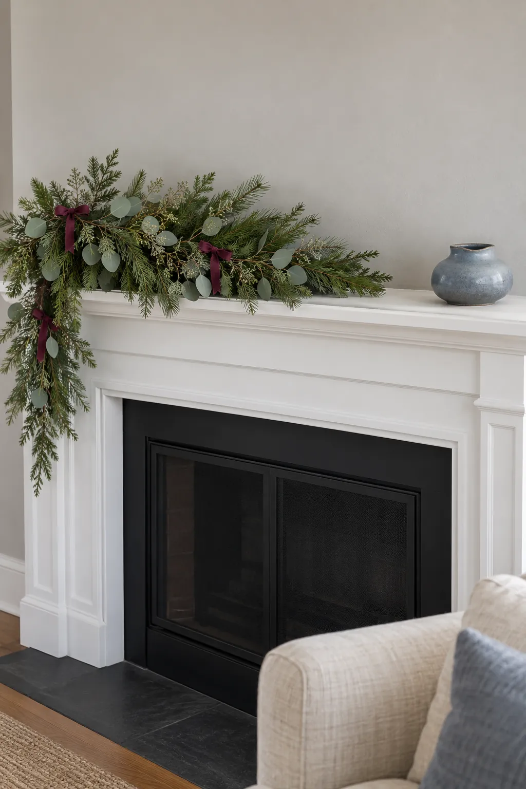Balance with space and one restrained accent when arranging asymmetrical mantel greenery