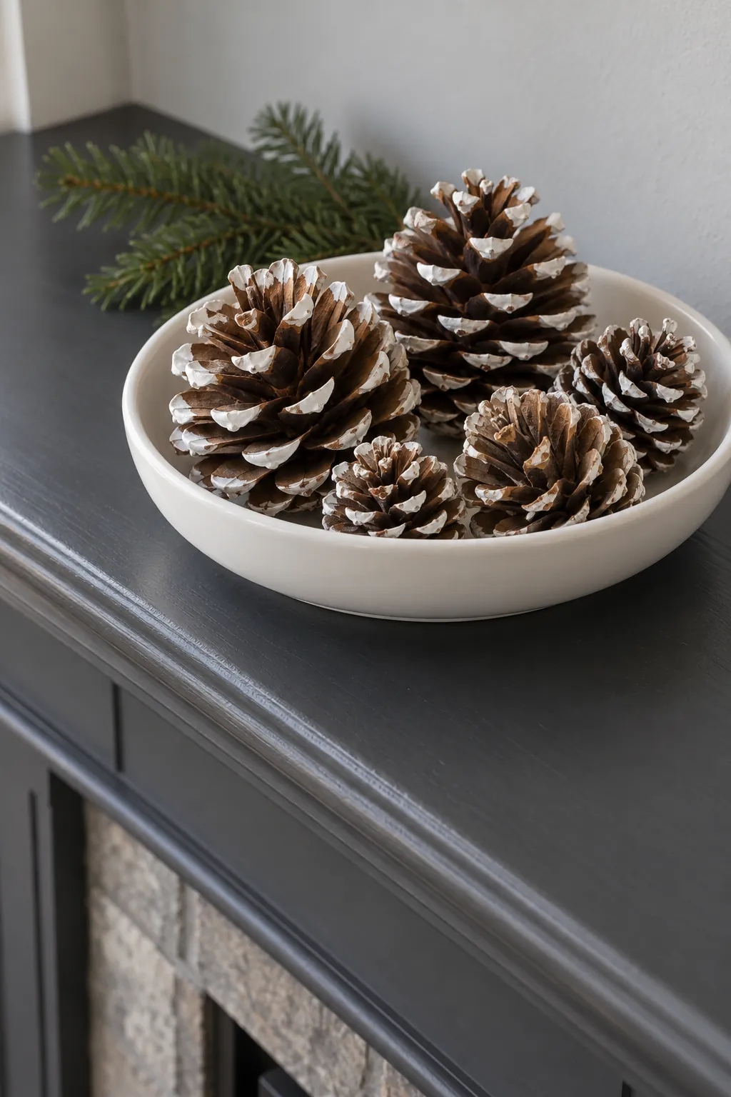 Highlight pinecone tips with white for white Christmas mantel decor