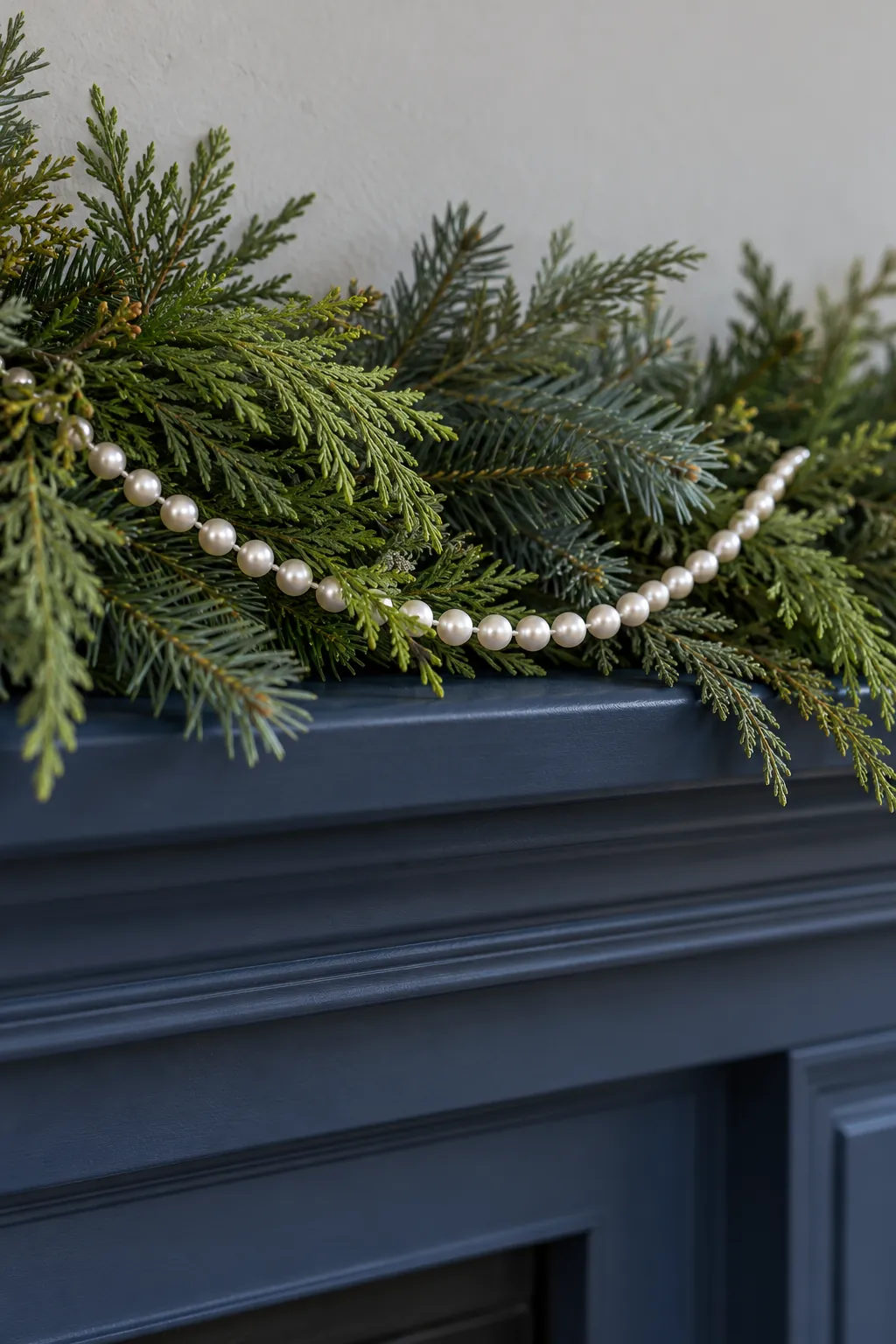 Drape a pearl style bead strand for white Christmas mantel decor