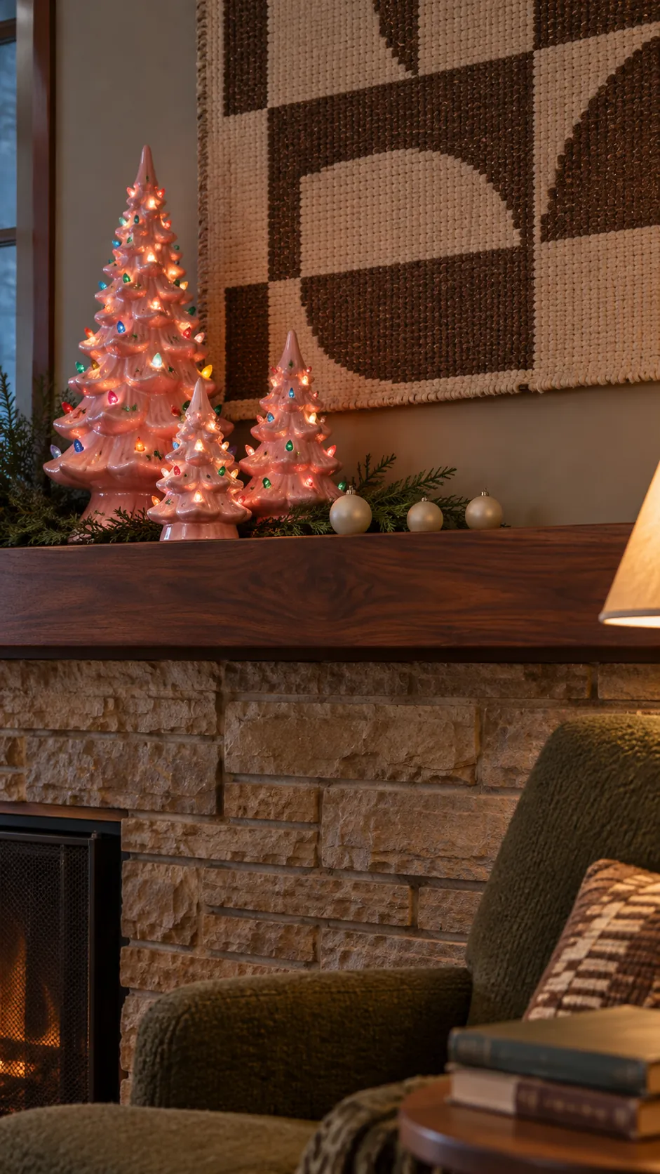 Retro pink ceramic Christmas trees glowing on a mantel