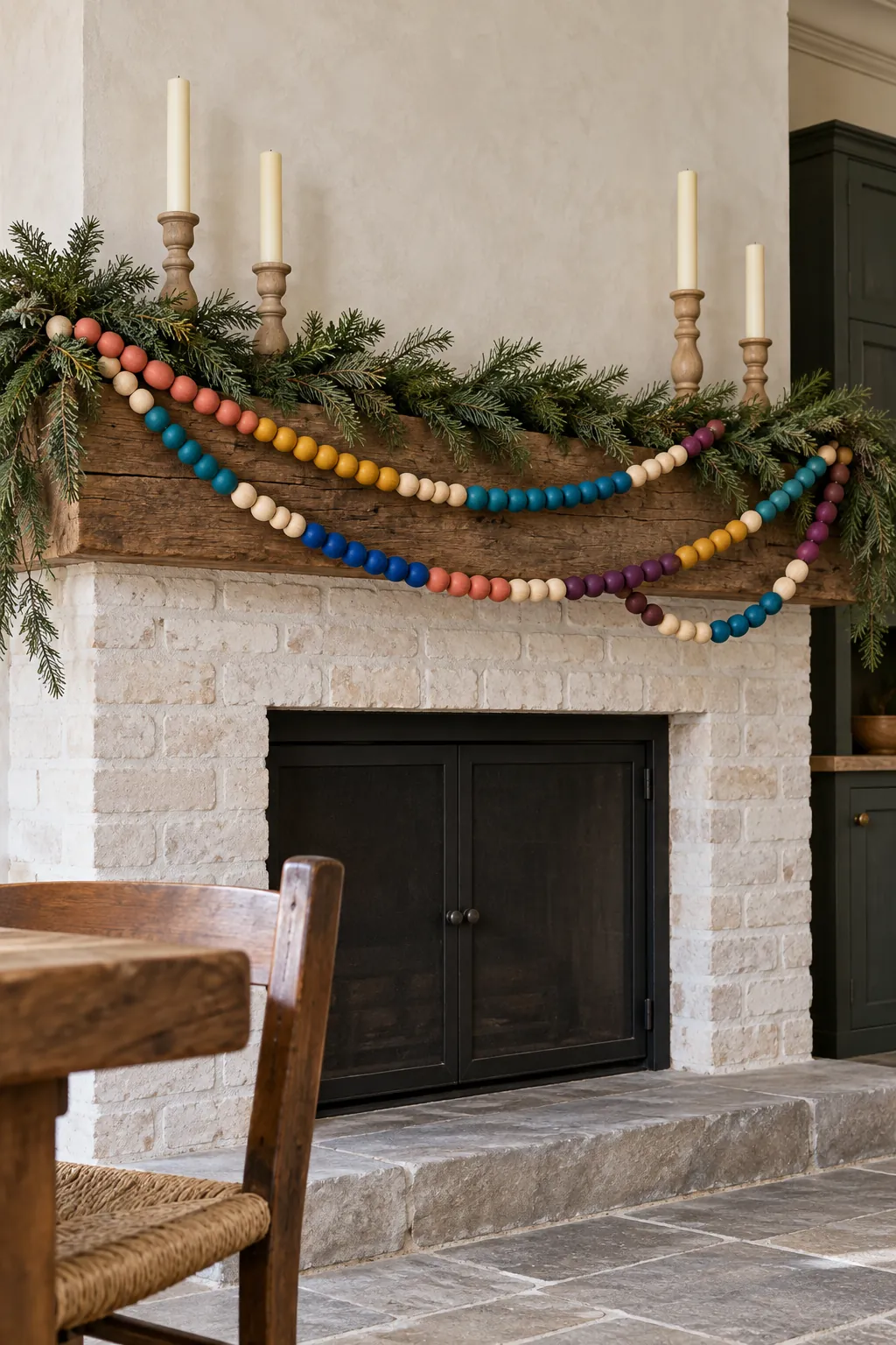 Painted wood bead color bands draped across Christmas mantel greenery
