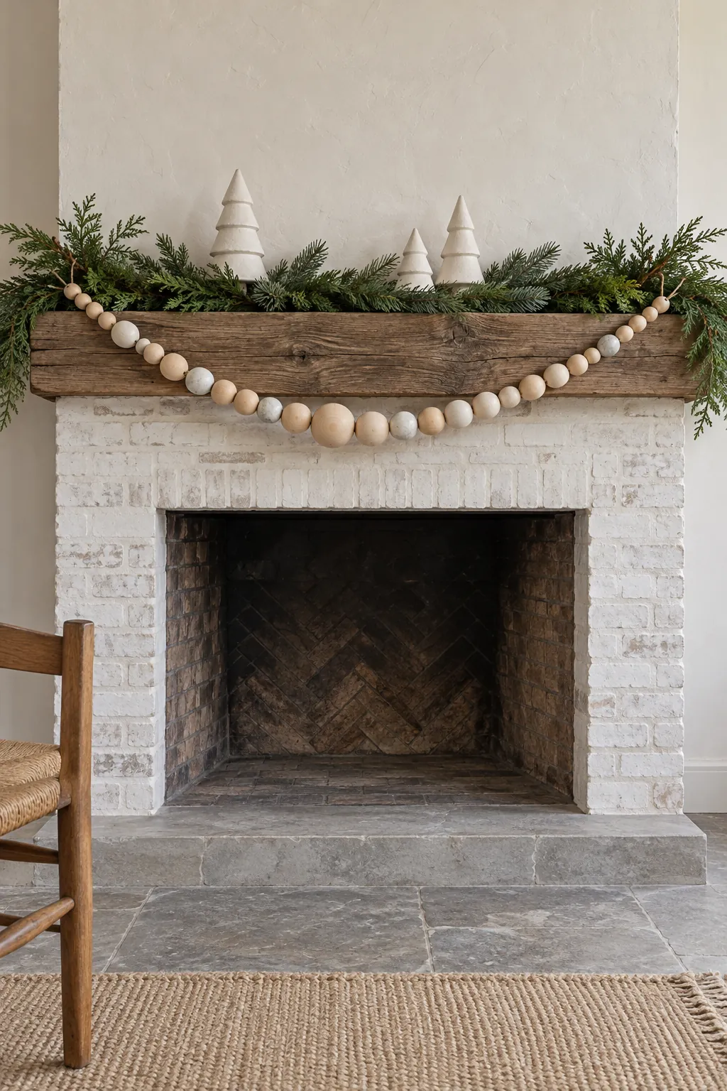 Natural wood bead garland draped across neutral Christmas mantel greenery