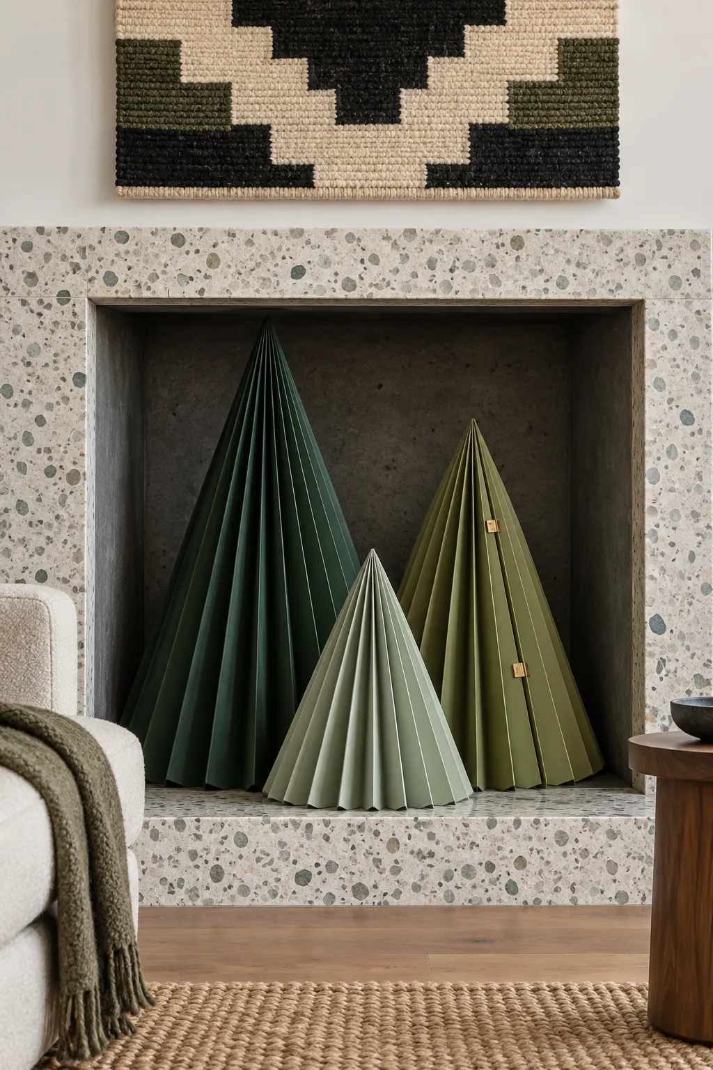 Oversized folded paper Christmas trees in a decorative fireplace