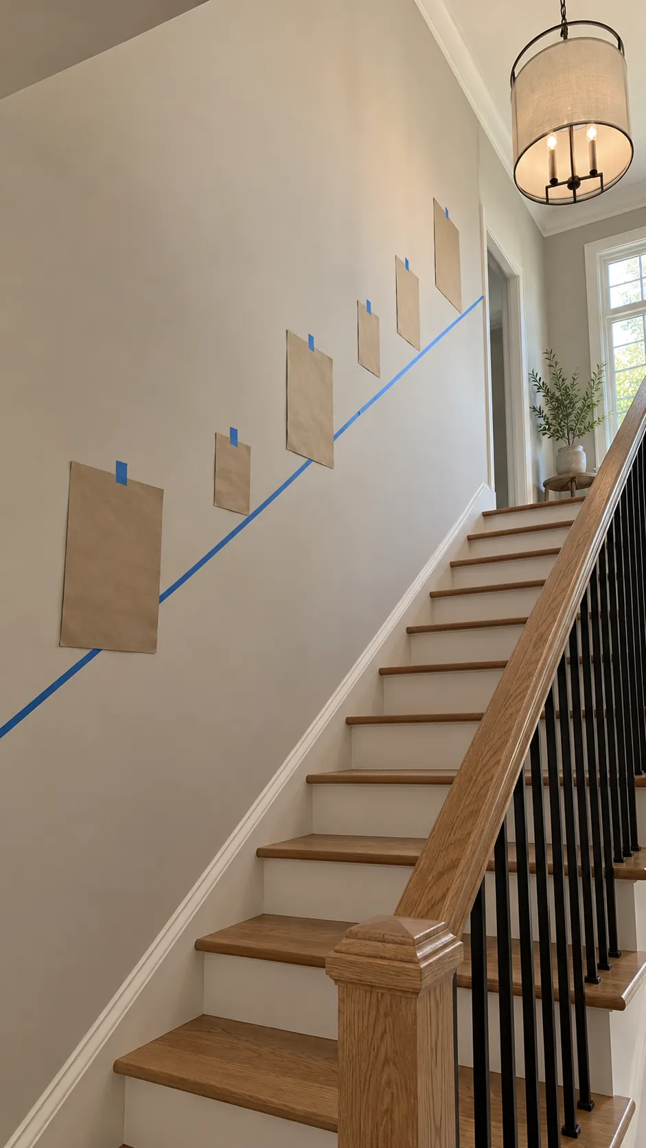 Removable tape marking a gallery wall center line above stairs