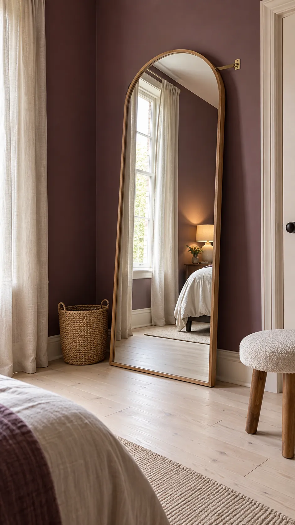 Secure floor mirror reflecting light in a spacious bedroom